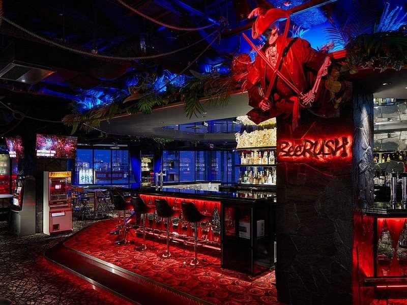 The interior of a small Osaka bar lit in red and blue