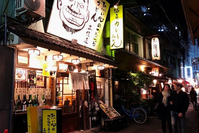 Izakaya frontages and lantern signs on a Dotonbori side street