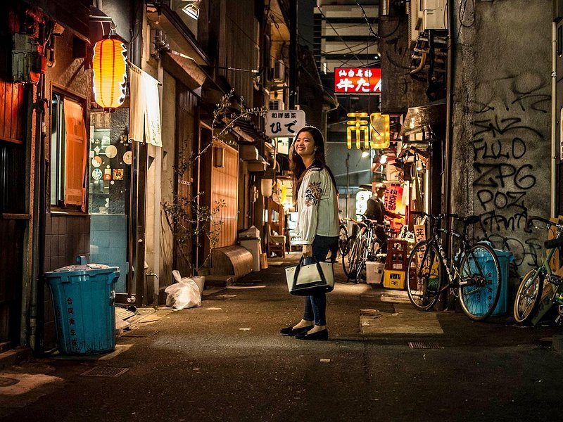 Paper lanterns over a narrow drinking alley in Uranamba