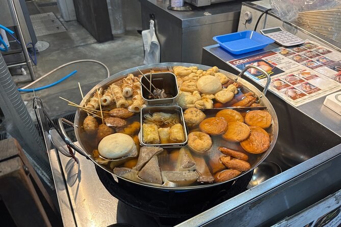 An oden pot simmering on a counter in an Osaka eatery